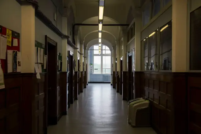 Dimly lit, empty school hallway